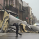 A man passes by a section of roof that was blown off of a building in the French Quarter by Hurricane Ida winds, Sunday, Aug. 29, 2021, in New Orleans.